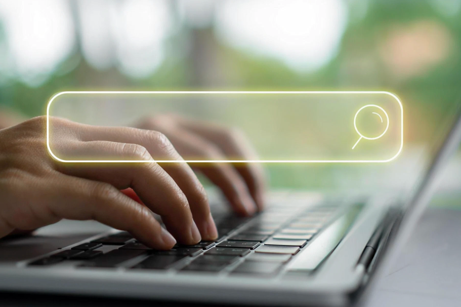 Person typing on computer with search bar, illustrating mass keyword lists vs. targeted keyword sectors
